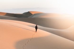 person walking on desert